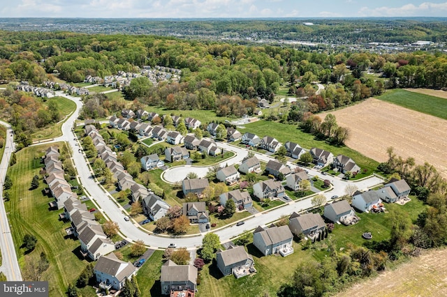 bird's eye view featuring a wooded view and a residential view