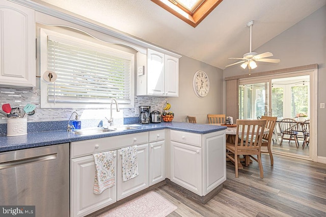 8 Candytuft Ln, Ocean Pines, MD 21811 - kitchen with a sink, decorative backsplash, light wood-style flooring, dark countertops, and dishwasher
