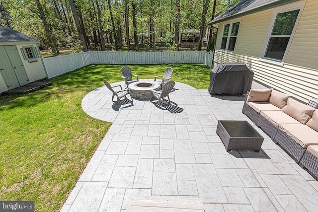 8 Candytuft Ln, Ocean Pines, MD 21811 - view of patio / terrace featuring an outdoor living space with a fire pit, a grill, a fenced backyard, and an outbuilding
