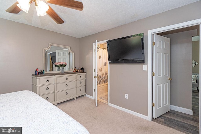 8 Candytuft Ln, Ocean Pines, MD 21811 - bedroom with ensuite bath, light colored carpet, ceiling fan, baseboards, and a textured ceiling