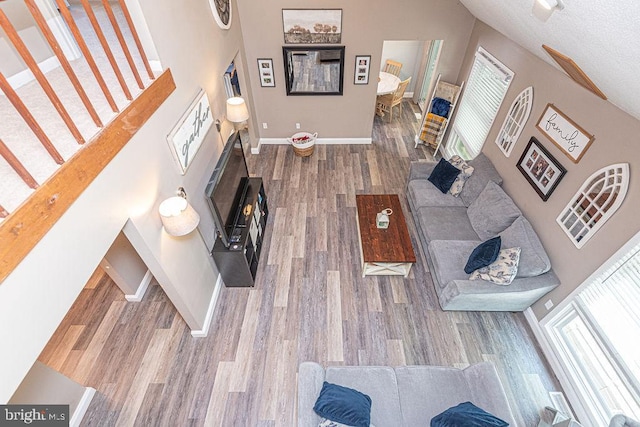 8 Candytuft Ln, Ocean Pines, MD 21811 - living area featuring a towering ceiling, stairs, wood finished floors, and baseboards