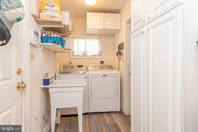 8 Candytuft Ln, Ocean Pines, MD 21811 - laundry area featuring wood finished floors, a sink, cabinet space, and independent washer and dryer