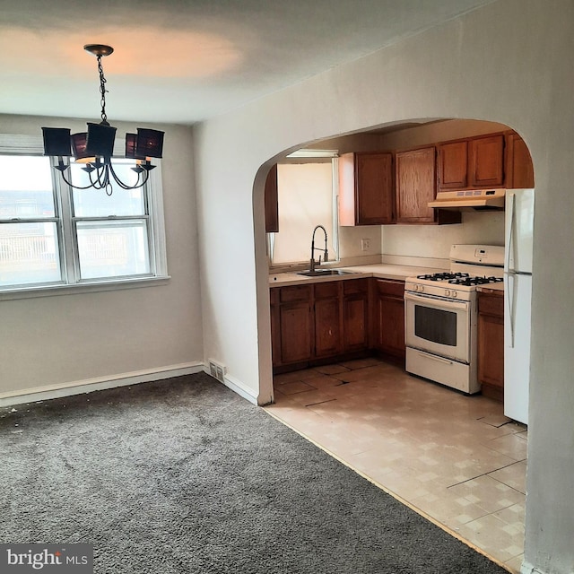6937 Stenton Ave, Philadelphia, PA 19138 - kitchen featuring a sink, white appliances, arched walkways, under cabinet range hood, and visible vents