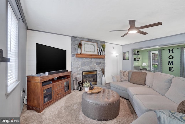 living room featuring ceiling fan, a fireplace, and carpet floors