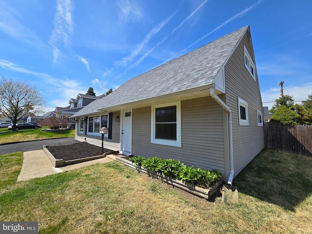 bungalow-style house featuring fence and a front yard