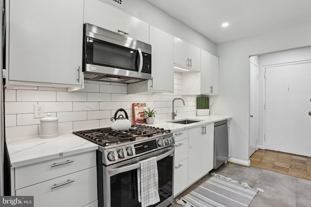 4201 Cherry Hill Rd Unit 110, Arlington, VA 22207 - kitchen with backsplash, stainless steel appliances, white cabinetry, and a sink