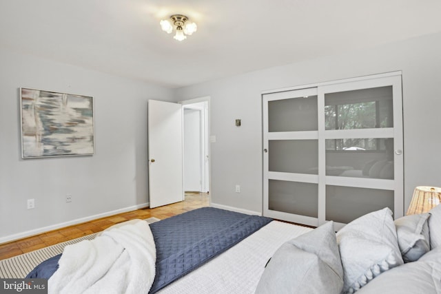 bedroom with baseboards and a closet