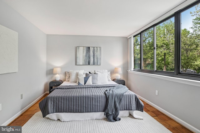 bedroom with baseboards and multiple windows