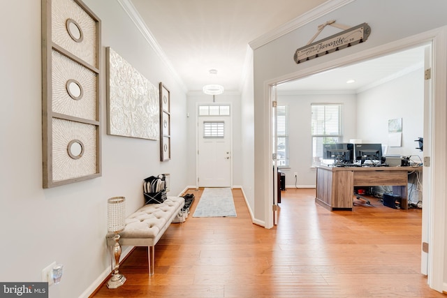 entryway featuring crown molding, baseboards, and hardwood / wood-style floors