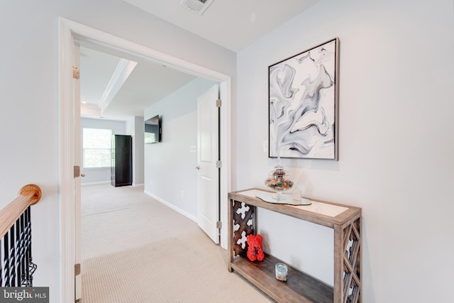corridor with carpet floors, baseboards, and visible vents