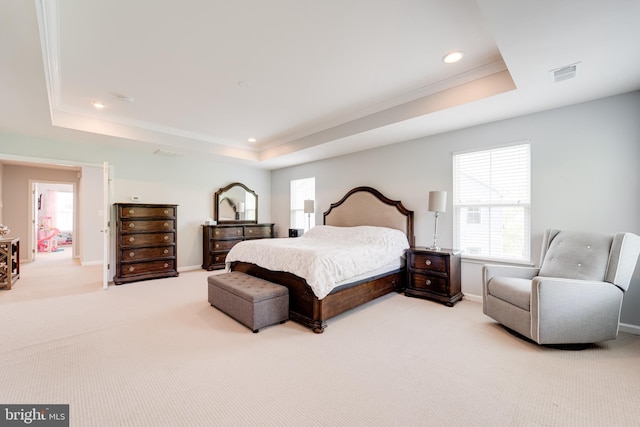 carpeted bedroom featuring multiple windows, visible vents, and a raised ceiling
