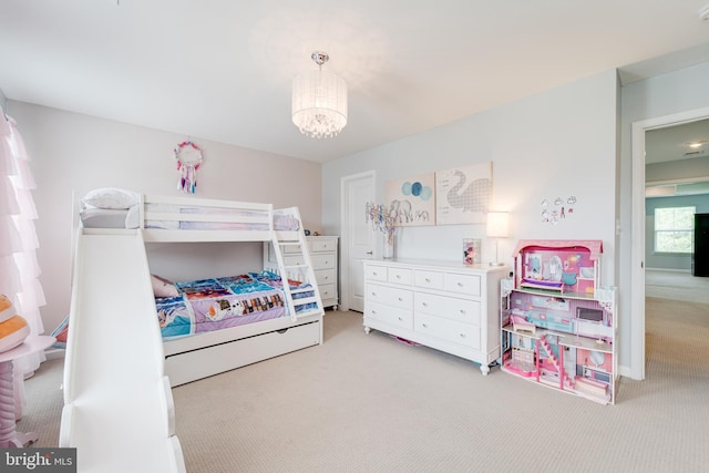 bedroom with light carpet and a notable chandelier