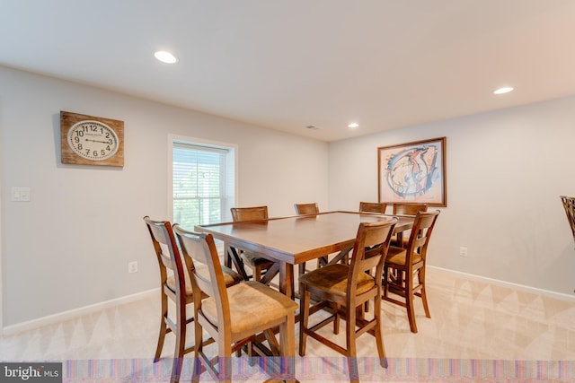 dining area featuring baseboards, light carpet, and recessed lighting