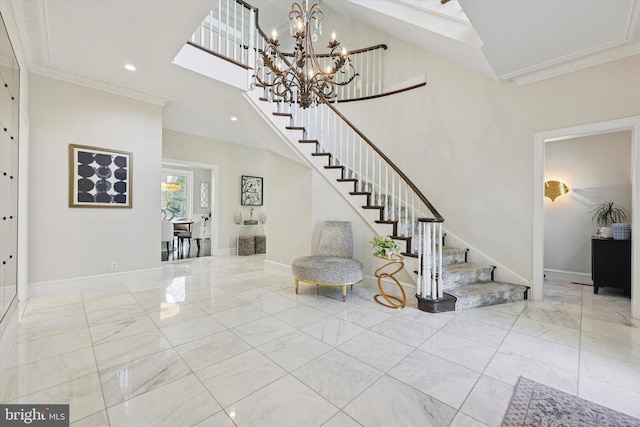 foyer entrance featuring baseboards, ornamental molding, stairs, and marble finish floor