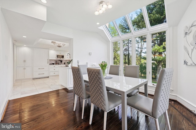dining room with baseboards, recessed lighting, light wood finished floors, and a notable chandelier