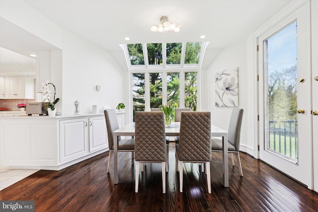 dining space with an inviting chandelier, recessed lighting, and dark wood-style floors