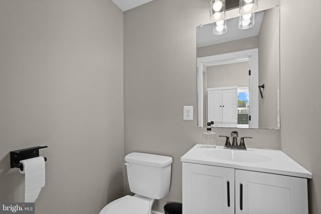 half bathroom featuring toilet and vanity
