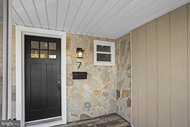 doorway to property with stone siding