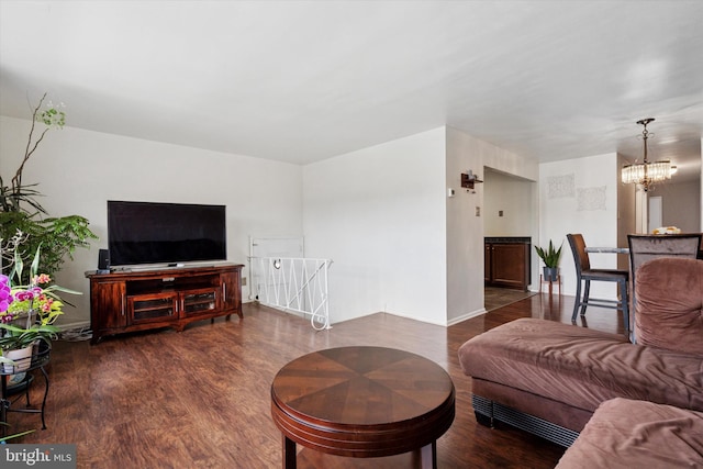 living area with wood finished floors and a notable chandelier