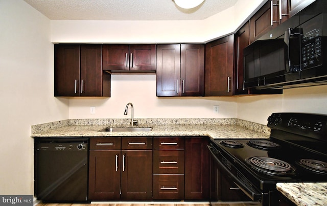 90 Catherine Ct, Levittown, PA 19057 - kitchen with dark brown cabinetry, a textured ceiling, light stone countertops, a sink, and black appliances