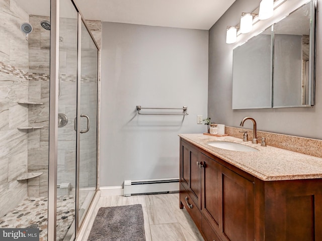 724 Webb St, Aberdeen, MD 21001 - bathroom featuring baseboard heating, vanity, and a shower stall