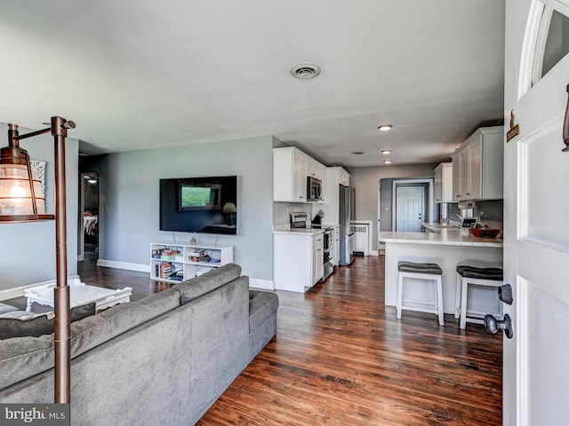 724 Webb St, Aberdeen, MD 21001 - living area featuring dark wood-style flooring and baseboards