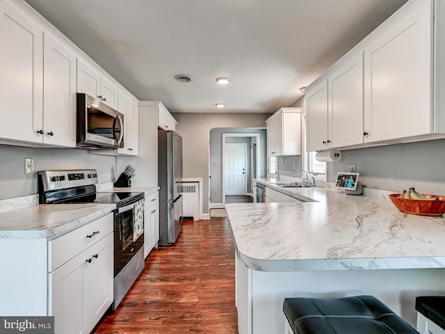 724 Webb St, Aberdeen, MD 21001 - kitchen with appliances with stainless steel finishes, dark wood-type flooring, light countertops, white cabinets, and recessed lighting