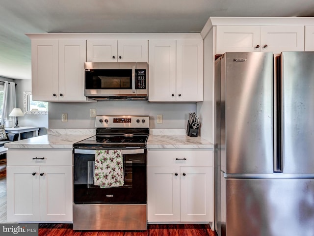 724 Webb St, Aberdeen, MD 21001 - kitchen with appliances with stainless steel finishes, white cabinetry, dark wood-style flooring, and light stone countertops