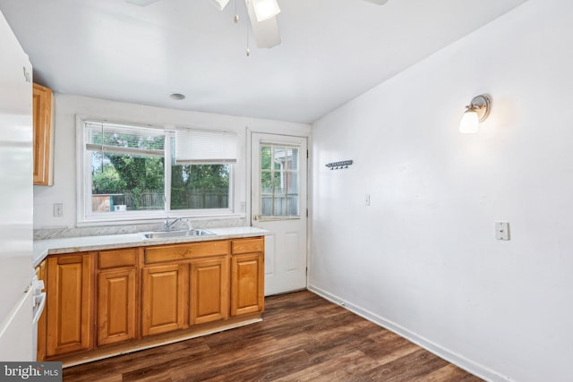 511 9th St, New Castle, DE 19720 - kitchen featuring a ceiling fan, freestanding refrigerator, a sink, dark wood-type flooring, and light countertops