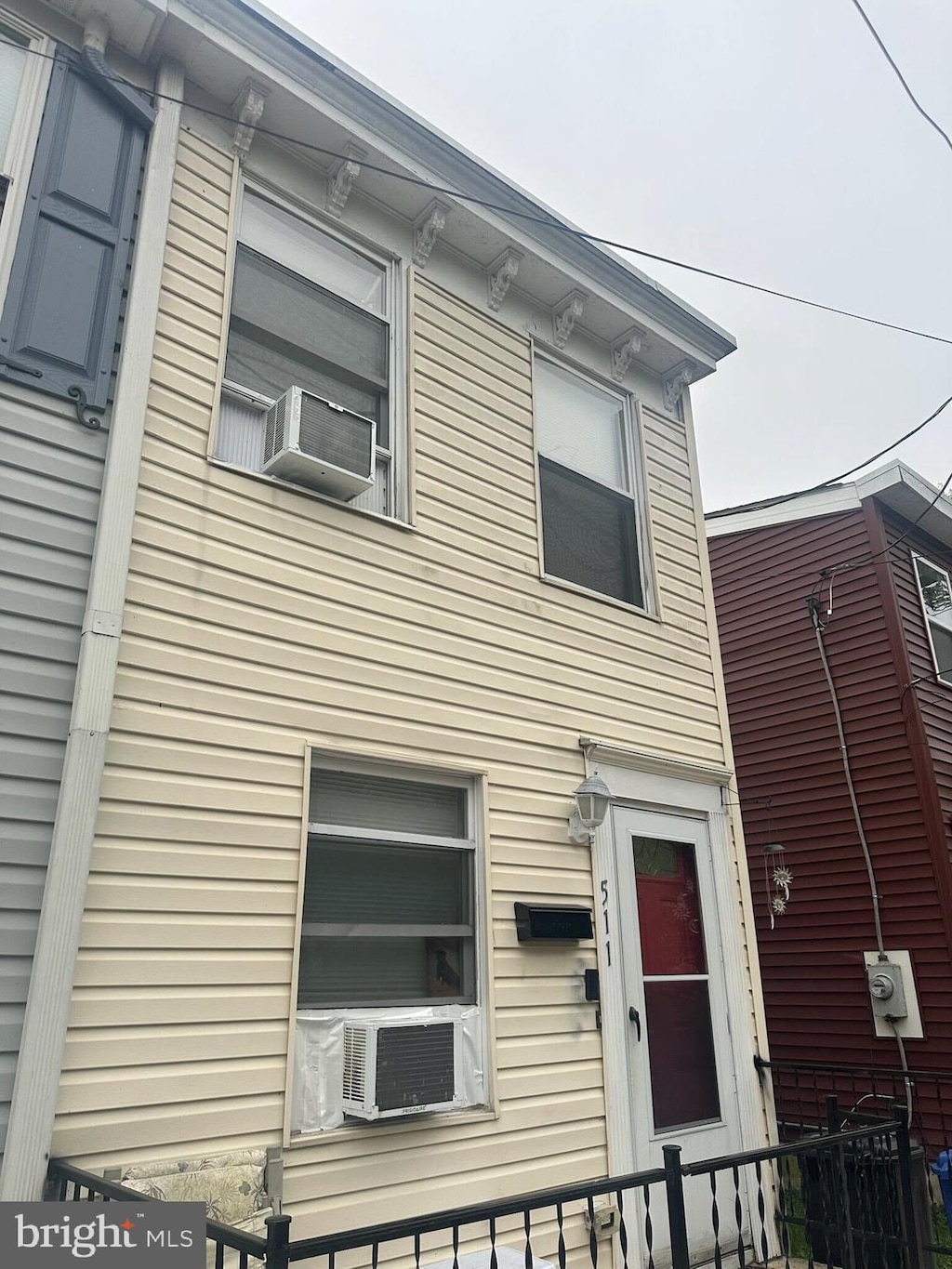 view of front of house featuring fence and cooling unit