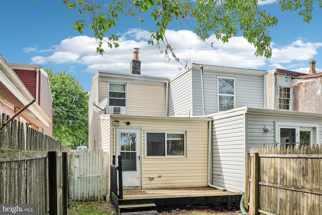 511 9th St, New Castle, DE 19720 - view of front of property with a chimney, a deck, and fence