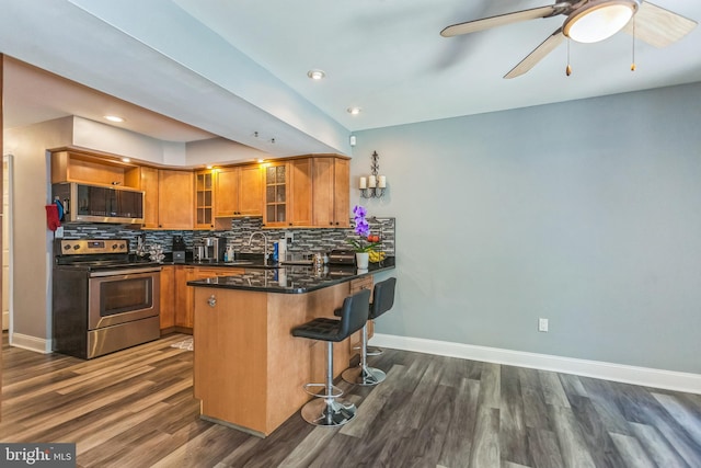 128 Granite Hill Ct, Langhorne, PA 19047 - kitchen featuring a peninsula, dark wood-style floors, brown cabinets, and stainless steel appliances