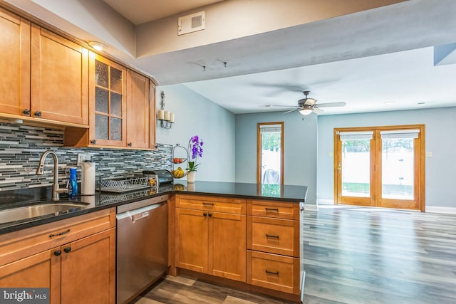 128 Granite Hill Ct, Langhorne, PA 19047 - kitchen with a sink, a peninsula, backsplash, wood finished floors, and stainless steel dishwasher