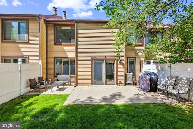 128 Granite Hill Ct, Langhorne, PA 19047 - rear view of house featuring a fenced backyard, a patio, an outdoor hangout area, and a yard