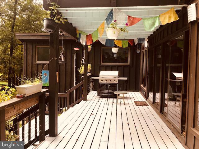 wooden terrace featuring grilling area