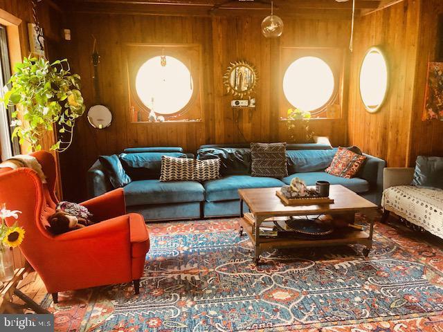 living area with wood walls