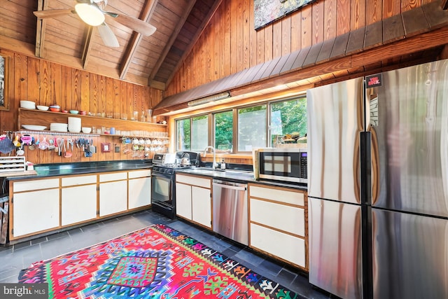 kitchen with white cabinets, dark countertops, appliances with stainless steel finishes, a sink, and wooden ceiling