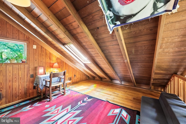 interior space featuring wood ceiling, lofted ceiling with beams, hardwood / wood-style flooring, and wood walls