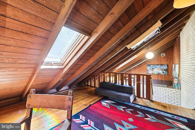 bedroom featuring wood walls, wooden ceiling, vaulted ceiling with skylight, and hardwood / wood-style floors