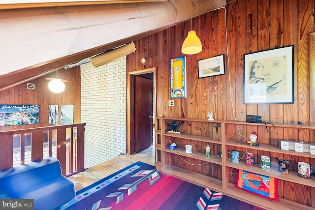 interior space featuring wood walls and wood finished floors