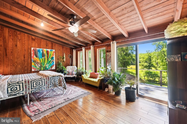 sunroom with plenty of natural light, lofted ceiling with beams, and wood ceiling
