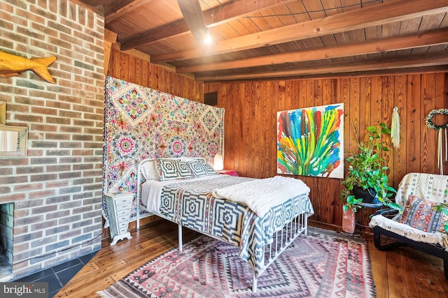 bedroom featuring wood walls, hardwood / wood-style flooring, wooden ceiling, and beamed ceiling