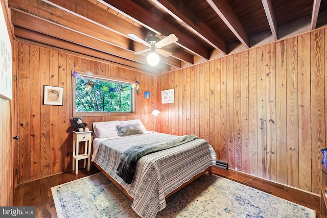 bedroom featuring wooden walls, beamed ceiling, wooden ceiling, and wood-type flooring