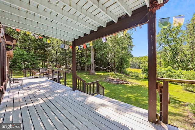 wooden terrace featuring a lawn, a pergola, and outdoor dining space