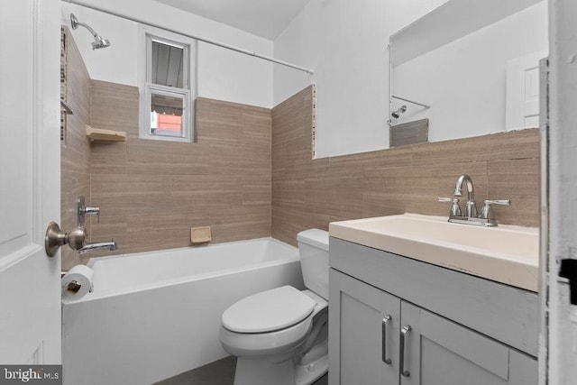 full bath with toilet, shower / bathtub combination, vanity, and tile walls