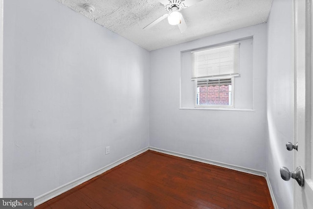 spare room featuring ceiling fan, baseboards, hardwood / wood-style floors, and a textured ceiling