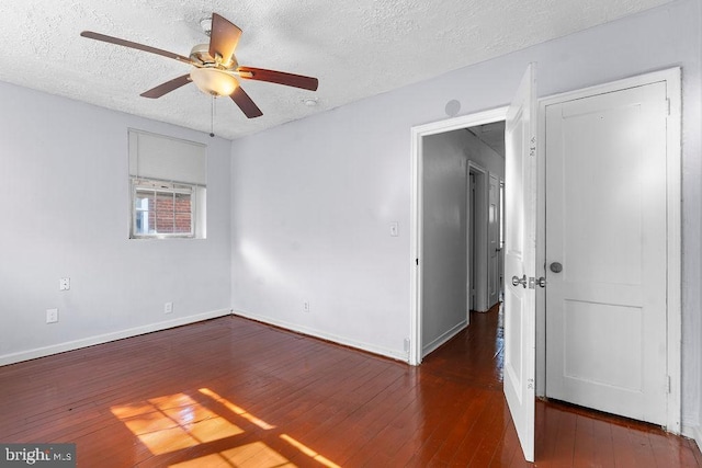 empty room with baseboards, a textured ceiling, hardwood / wood-style flooring, and ceiling fan