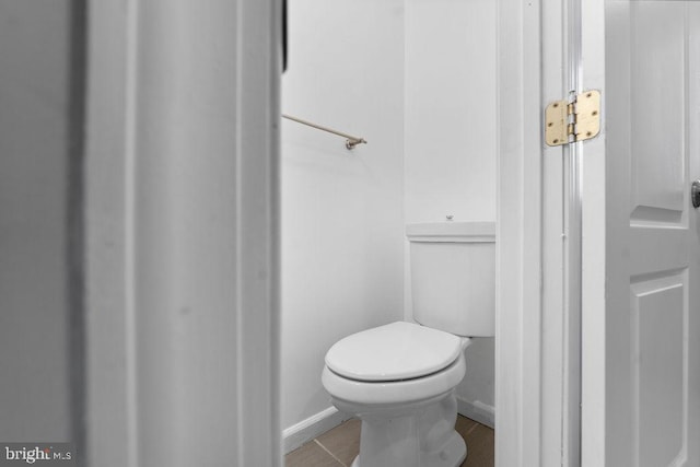bathroom with baseboards and toilet