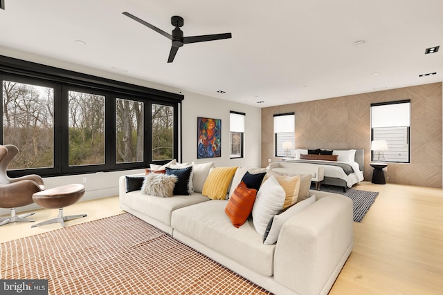 bedroom featuring wallpapered walls, wood finished floors, and a ceiling fan