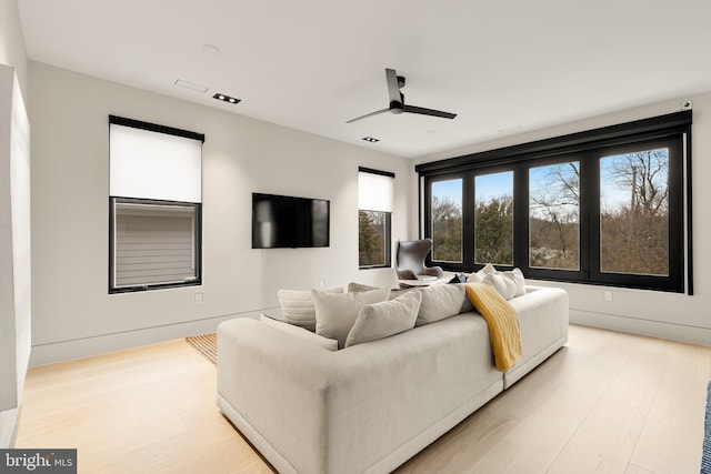 living room with ceiling fan and light wood finished floors